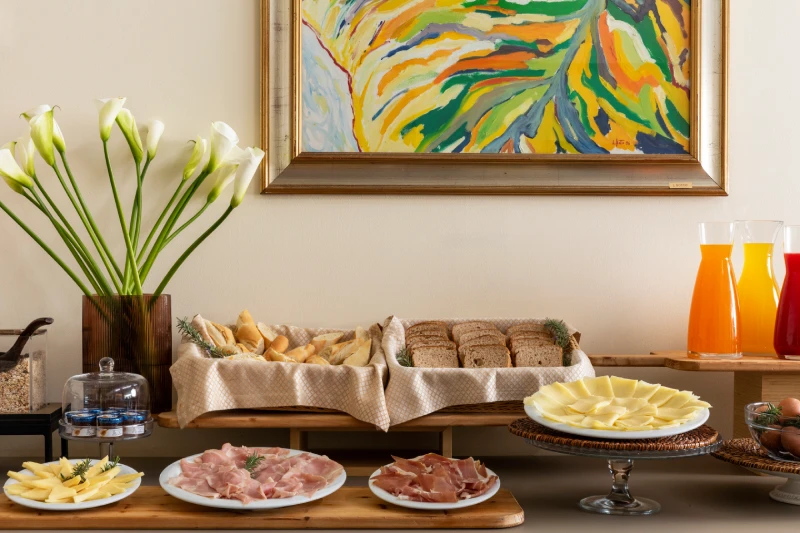 Savory breakfast with cheeses and cured meats, bread and juices on a refined buffet for Liguria holidays - Hotel Al Sant'Andrea, BZAR hotels in Liguria
