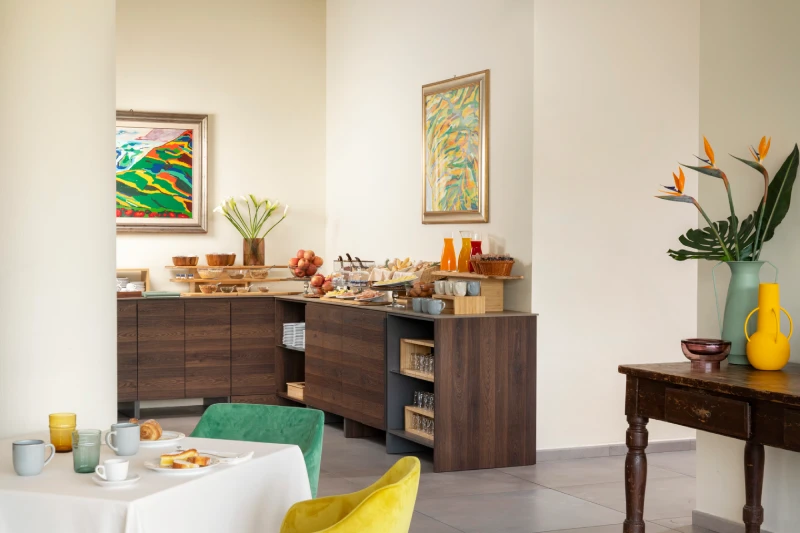 Breakfast room with buffet and colorful seating in Sarzana, ideal for stays between the Cinque Terre and Liguria - Hotel Al Sant'Andrea, BZAR hotels in Liguria