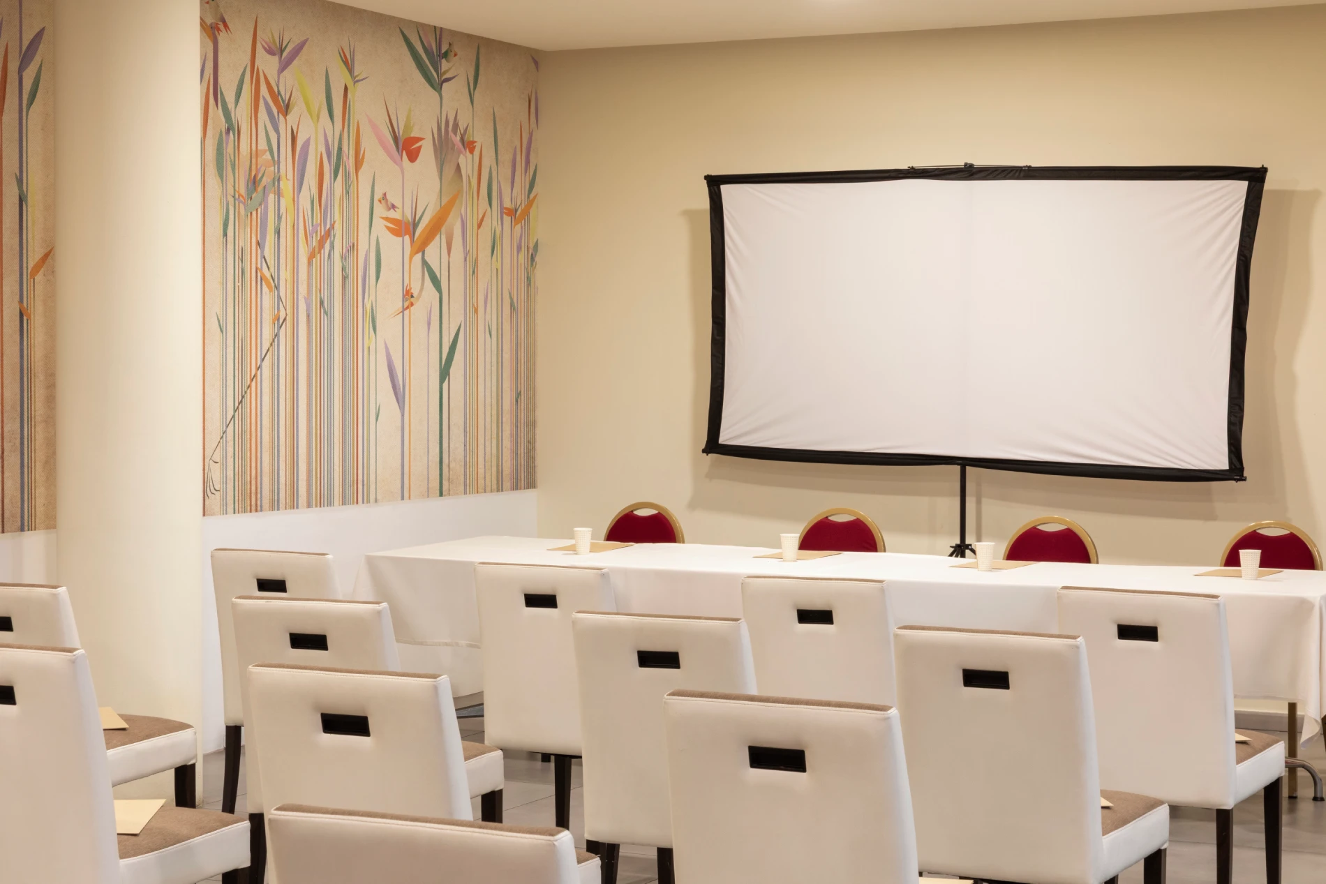 Meeting setup with speaker table, screen and seating, ideal for conferences and business meetings in Liguria - Hotel Al Sant'Andrea, BZAR hotels in Liguria