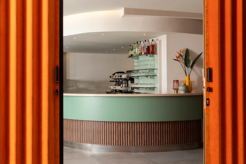 Modern hotel bar with curved counter, displayed bottles and lounge vibe, perfect after a day exploring Liguria - Hotel Al Sant'Andrea, BZAR hotels in Liguria