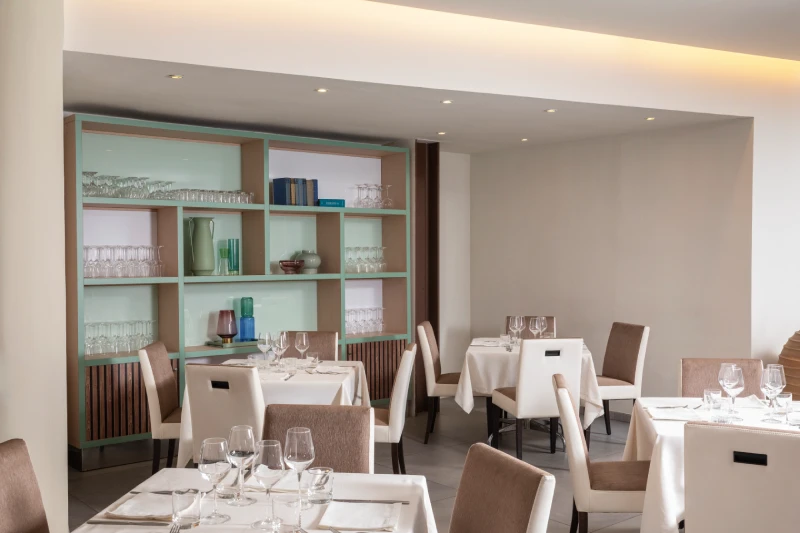 Bright restaurant with complete table setting and glassware shelving, refined space for stays in Sarzana, Liguria - Hotel Al Sant'Andrea, BZAR hotels in Liguria