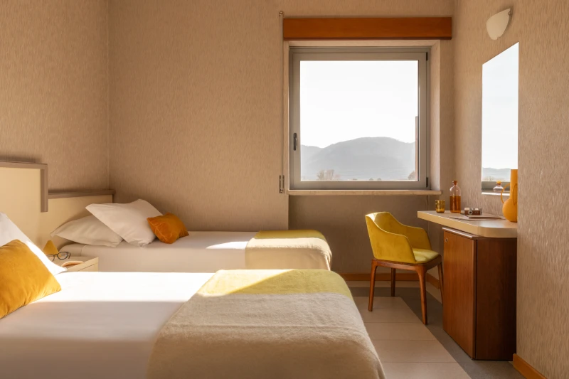 Triple room with single beds, warm tones and workspace, ideal for group stays in Sarzana, Liguria - Hotel Al Sant'Andrea, BZAR hotels in Liguria
